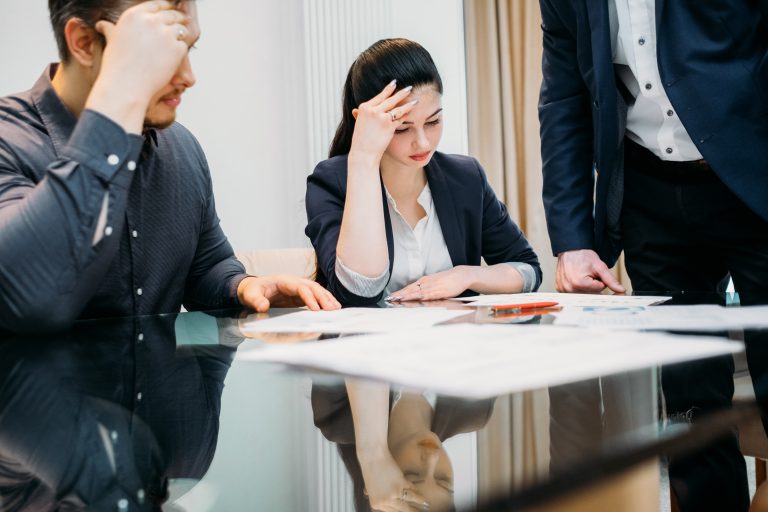 man and woman sitting depressed at the lawyer office